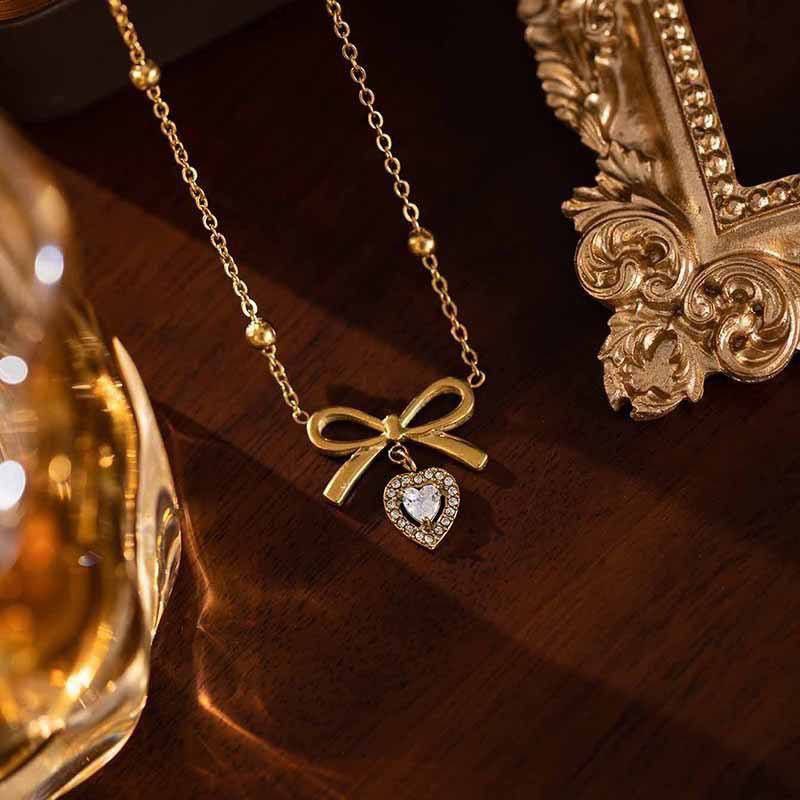 Elegant Bow Necklace with Crystal Heart Pendant